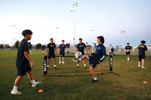 Members of the Downtown Las Vegas Soccer Club warm up during practice at Cragin Park on February 28.