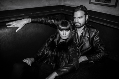 Grounded in Belgium’s electro lineage, the band balances reverence with reinvention. Its sound pairs Gaelle Souflet’s hypnotic synth lines with Sam Hugé’s commanding baritone.