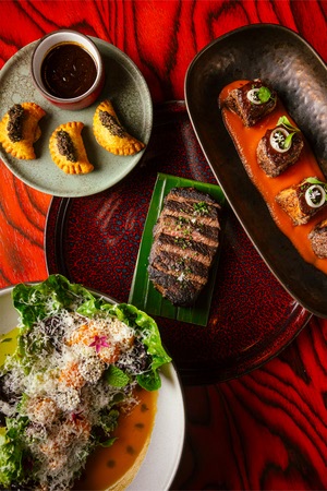 Maroon patties, crispy Chilean oversea  bass, rum-aged steak and piri piri chop salad