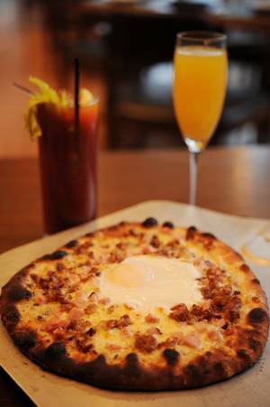 A breakfast pizza and a mimosa might be the perfect way to kick a morning hangover. If that doesn't work, the host stand at Simon is stocked with Pepto and Tums. 