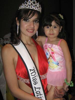Gladys Gonzales, 23, last year's Latina Belleza pageant queen, holds another contestant.