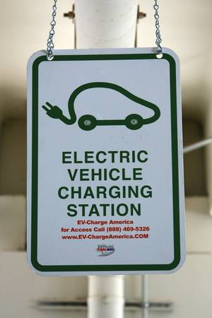 An electric-car charging station sign at Rampart Casino.