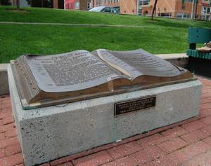 This bronze book tells the history of Park Central Square in Springfield, Missouri, minus one important element, added in the form of a plaque on the front of the monument.
