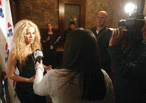 Shakira being interviewed on the red carpet.