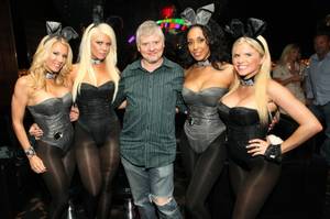 Dave Foley is flanked by Playboy Bunnies at the Palms.