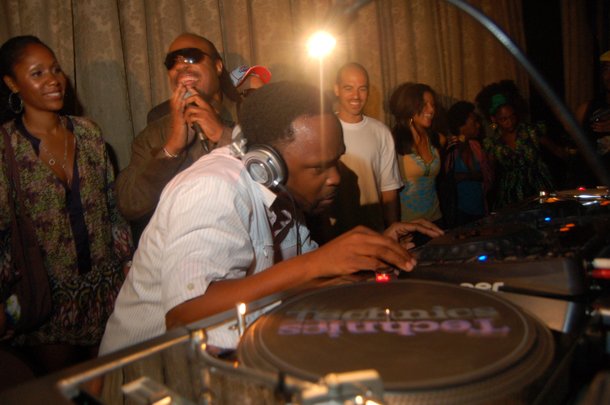 DJ Spinna works the turntables with Stevie Wonder nearby at a past WONDER-Full event.