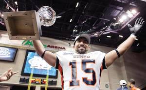 Raul Vijil of the Spokane Shock celebrates with the 2009 ArenaCup trophy after his team defeated the Wilkes-Barre/Scranton Pioneers Saturday, 74-27.