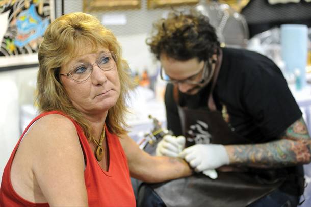 A woman gets ink at the Biggest Tattoo Show on Earth.