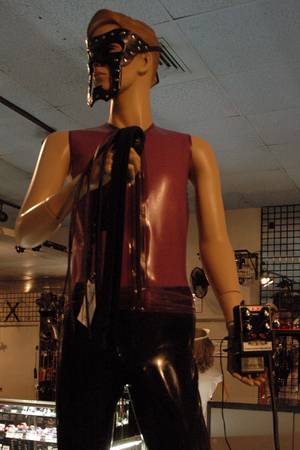A mannequin displays the P.E.S. power box (and some light bondage gear).