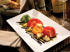 Mozzarella and heirloom tomatoes with sweet balsamic syrup at Envy.