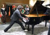 Pianist Eric Lewis (ELEW) plays on his feet for guests at Fendi at Crystal's grand opening.