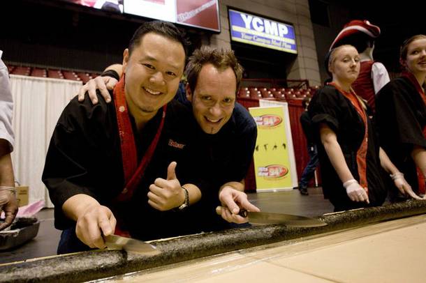 Jet and Kevin Brauch with the practice sushi roll for a Guinness Record attempt.