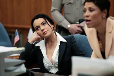 Lindsay Lohan sits in court before receiving her new accessory. 