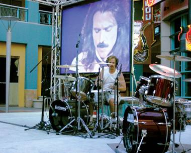 Charlie Adams, drumming outdoors at Neonopolis