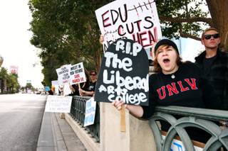 Mona Shield Payne / Special to the Sun..UNLV psychology major Jordan Gustaitis, 21, chants as cars pass by while attending a protest against education budget cuts Sunday, March 6, in front of the Bellagio on the Las Vegas Strip.