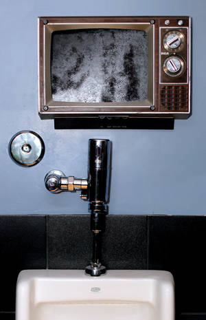 Old television sets were turned into frames for artwork in the men's room at Artifice.