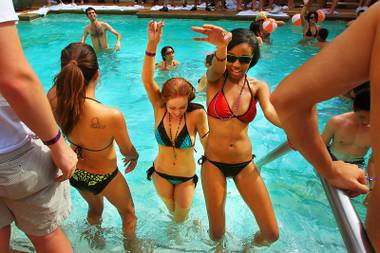 Women dance in the pool during opening day for Tao Beach Saturday, April 2, 2011.