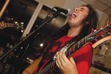 Vincent Mazzoccoli, lead singer of Deep Fried Orphanz, thrashes during a recent performance.