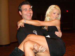 Friess carries <em>Peepshow</em> star and Playboy model Holly Madison over scary carpet. What a gentleman.