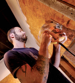 Chicago artist Scott Carter works on his installation opening at the Contemporary Arts Center