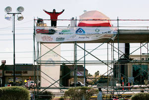 Chet Buchanan stands on a 30-foot-high scaffolding platform where he'll remain 24 hours a day for the 12-day Toy Drive.