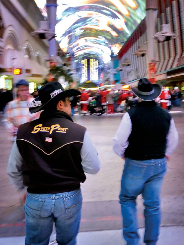 Some cowboys take in the Fremont Street Experience while in town for NFR.