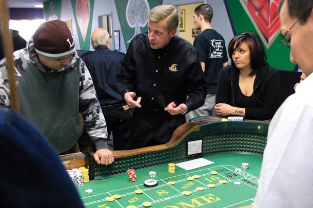Instructor Tommy Manning shows Crescent students the ropes. Many of them take a comprehensive course that teaches them table games from craps and poker to roulette and blackjack. 