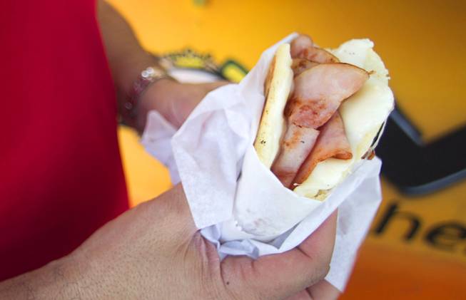 Alex Espita of Colombia holds a ham and cheese filled arepa at Viva Las Arepas on the northwest corner of Las Vegas Boulevard South and Wyoming Avenue Sunday, June 17, 2012. An arepa is a South American flat bread made of cornmeal or flour.
