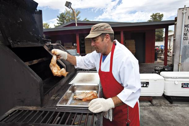 Chuck Frommer goes to work on some Road Kill Grill chicken, one of the best bites at the northwest barbecue shack.