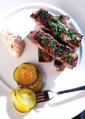 Vadouvan grilled lamb ribs with bread and butter pickles.