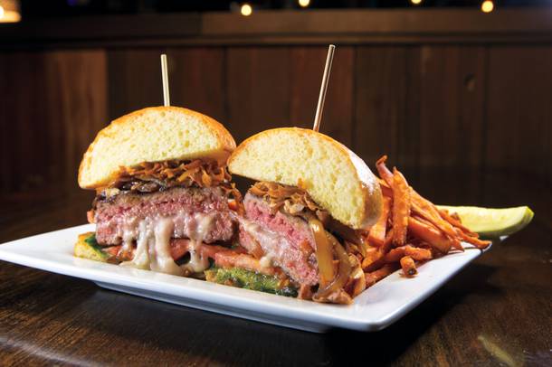 The Cure burger at Distill blends beef with pork, plus fontina cheese, jalapeño jelly, spicy mayo and fried parsnips.