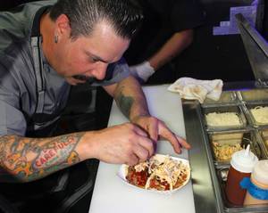 Mike Minor puts the finishing touches on some Truck U tacos.