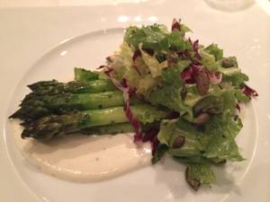 Postrio's asparagus salad with goat cheese fondue, escarole, pumpkin seeds and dijon-herb vinaigrette.