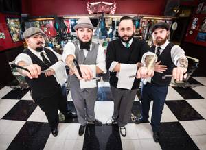 Barber Martin Corona (second from right) owns Downtown's Hi-Rollers Barbershop.