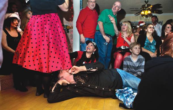 Still laughing: Johnathan Szeles, billed as The Amazing Johnathan during his performing days, peeks up the skirt of a friend at a Christmas party in December.