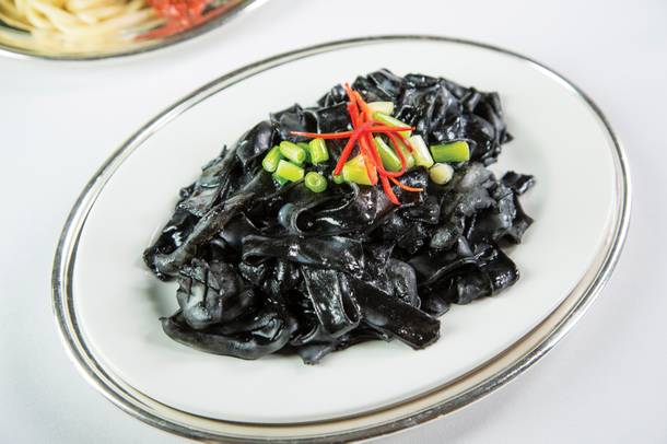 Rice noodles spiked with squid ink at Mr Chow.
