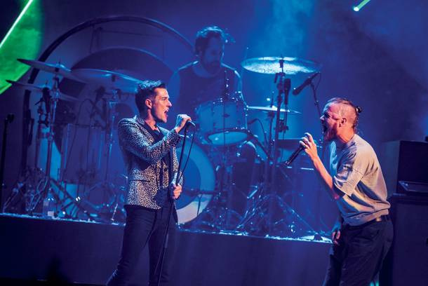 Imagine Dragons' Dan Reynolds joins the Killers onstage during T-Mobile Arena's opening night.