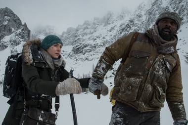 Winslet and Elba trudge through the wilderness.
