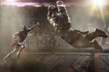 Thor and the Hulk fight in the arena.