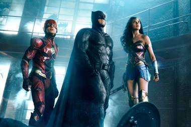 The Flash, Batman and Wonder Woman prepare for battle.