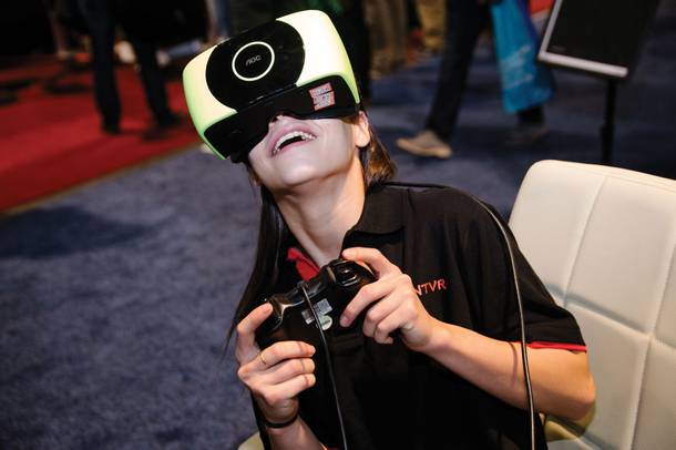 CES attendees get hands-on with VR tech. (Wade Vandervort / Staff)