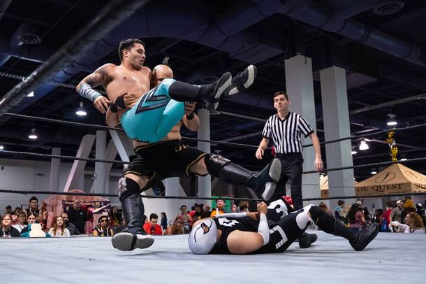 Mondo Deniro and Mondo Rox leg drop onto Dusk during a Versus Pro Wrestling match at the LVL Up Expo. (Wade Vandervort/Staff)