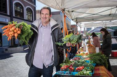 Adam Thomas, owner of Fresh52 Farmers’ & Artisan Market, at the Picked Today Produce booth in Tivoli Village