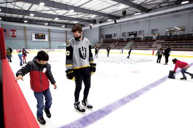 Silver Knights goalie Logan Thompson skates with a boy from Henderson’s Battle Born Kids program at Lifeguard Arena.