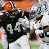 Raiders running back Jalen Richard (30) races past Browns linebacker Sione Takitaki, December. 20 in Cleveland.
