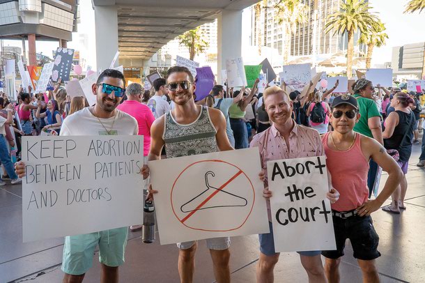 Farzad Alikozai (left) and friends at the march