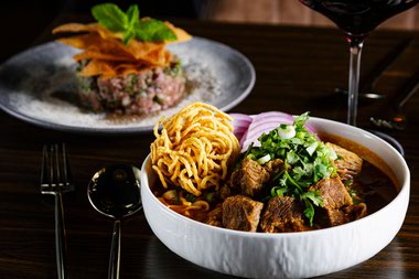 Lamaii’s kao soi and steak tartare, served with a Lioco Pinot Noir