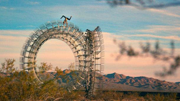 A Spiegelworld performer poses atop a Clayton Blake sculpture in Nipton, CA. 