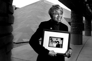 Debbie Conway holds a photo of herself with local activist and media personality Tanya Flanagan and California Congresswoman Maxine Waters.