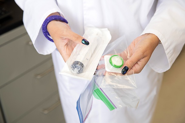 Louisa Messenger, a UNLV professor in the College of Public Health, shows a collection kit consisting of a large syringe and a filter in the Morphology Lab at UNLV Wednesday, Aug. 9, 2023. Information is collected onto the filter instead of collecting actual vials of water to test.